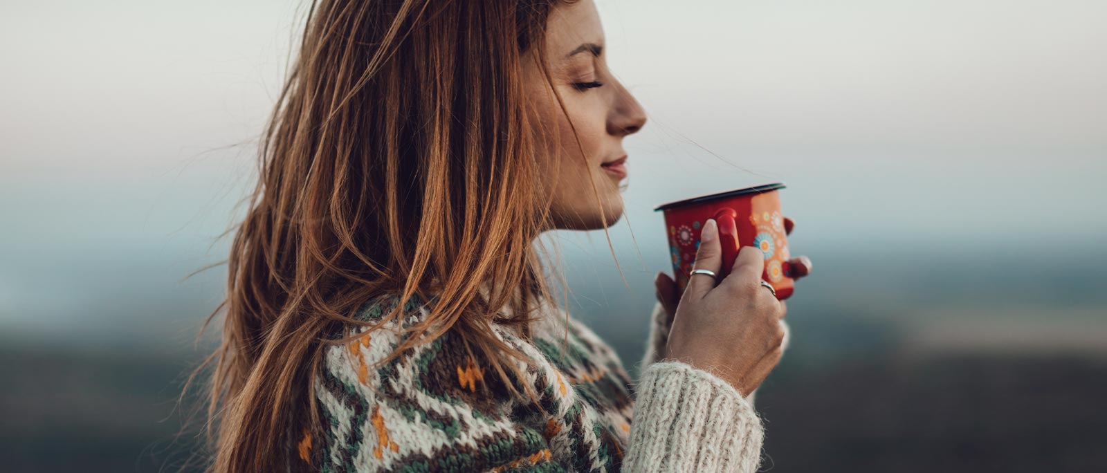 Woman enjoying a hot drink in winter